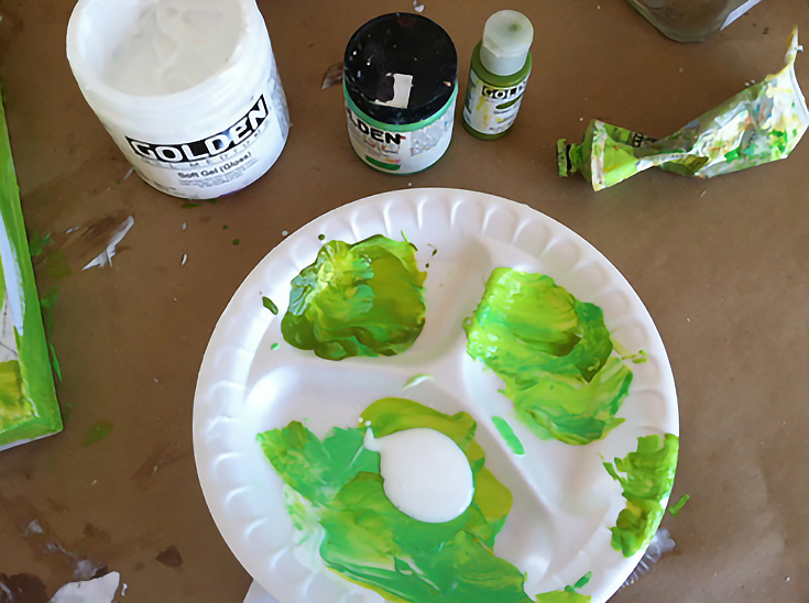 Mixing green paint for collage