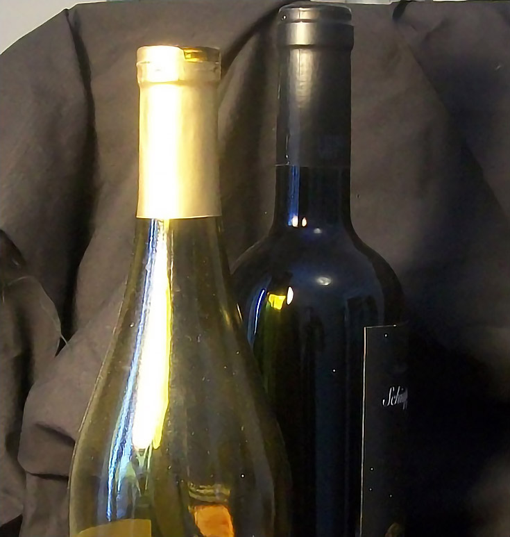 Photograph of two colored wine bottles