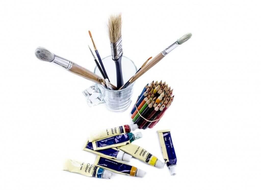 A collection of artist tools: brushes, pencils, paint
