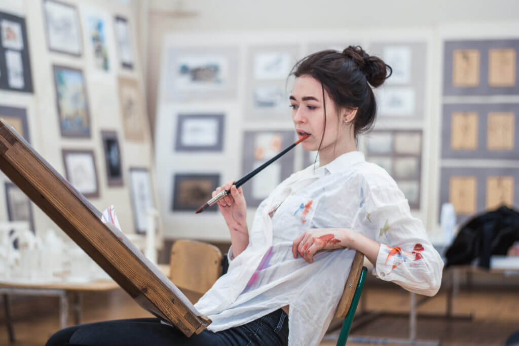 Woman in an art class with brush and paint