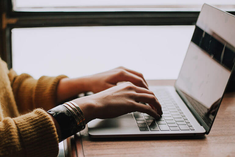 Woman typing on laptop