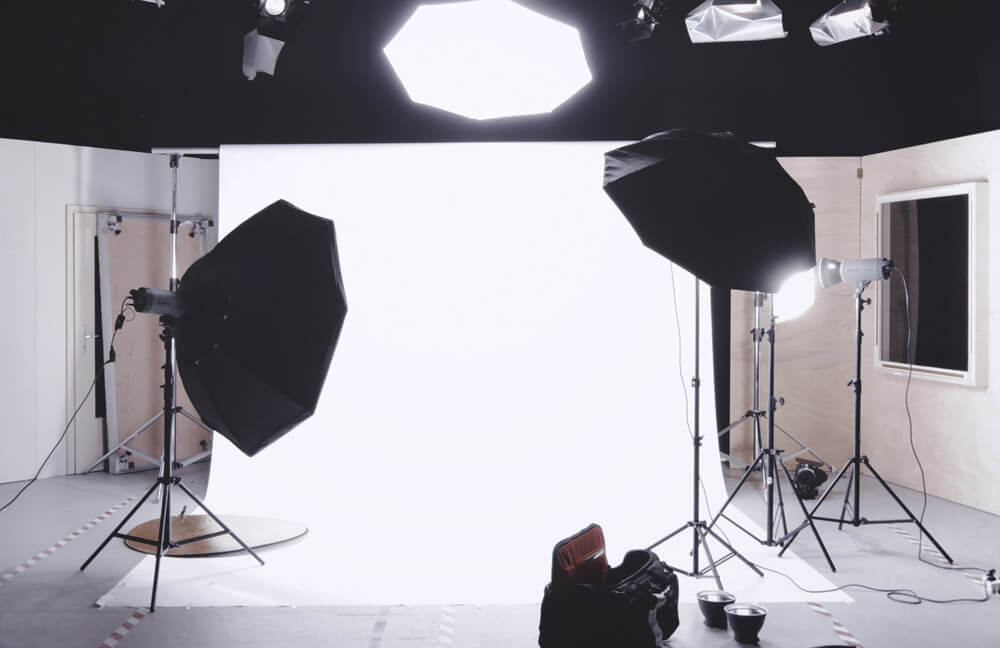 Photography studio with lights and white backdrop