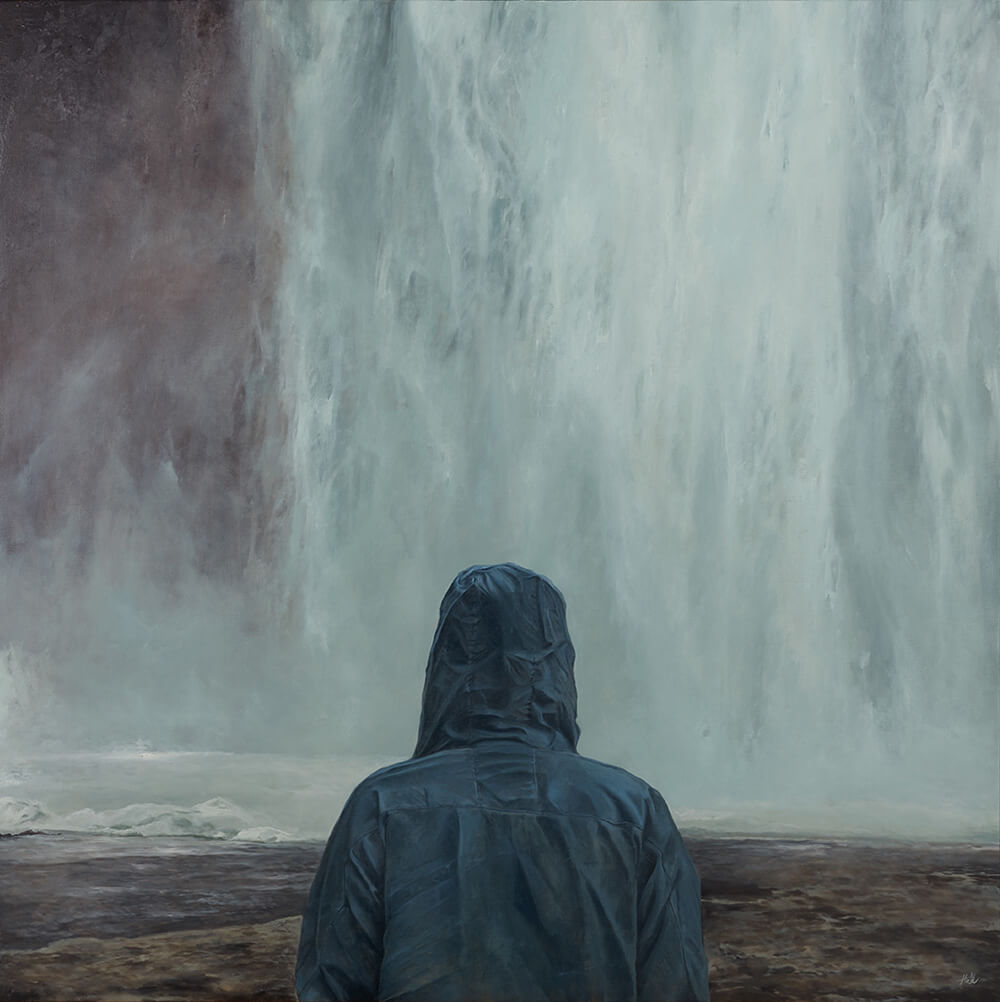 A figure in a blue raincoat stares at a waterfall