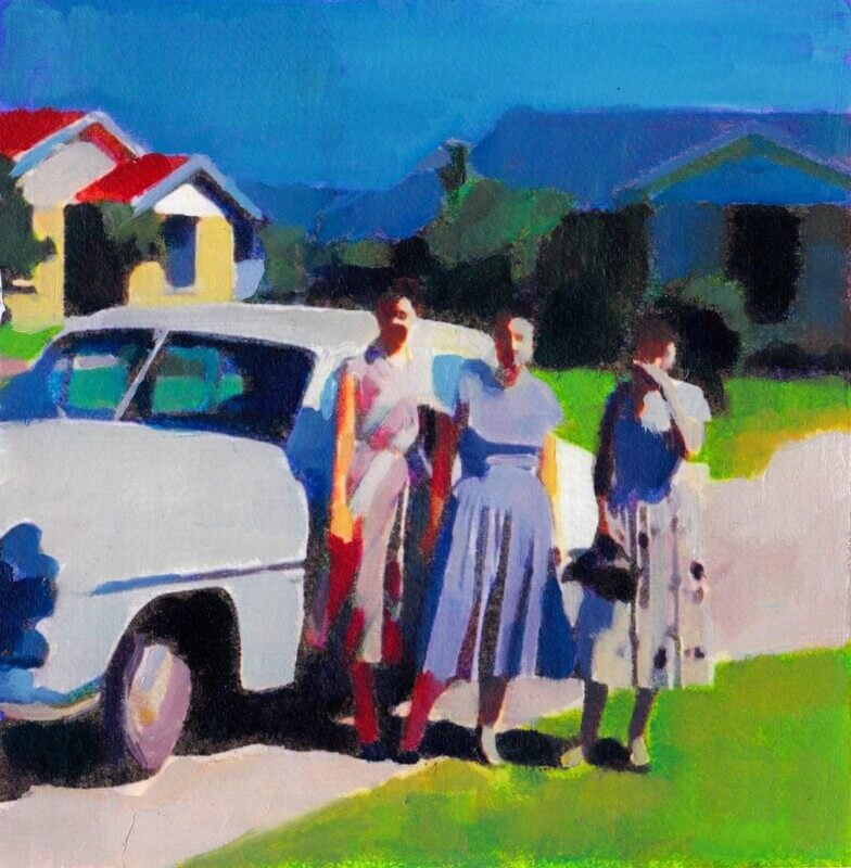Three women pose in front of a classic blue car