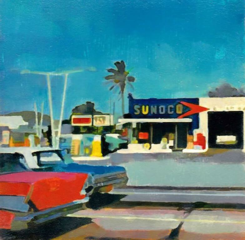 Classic automobiles parked next to a Sunoco station under palm trees and a bright blue sky
